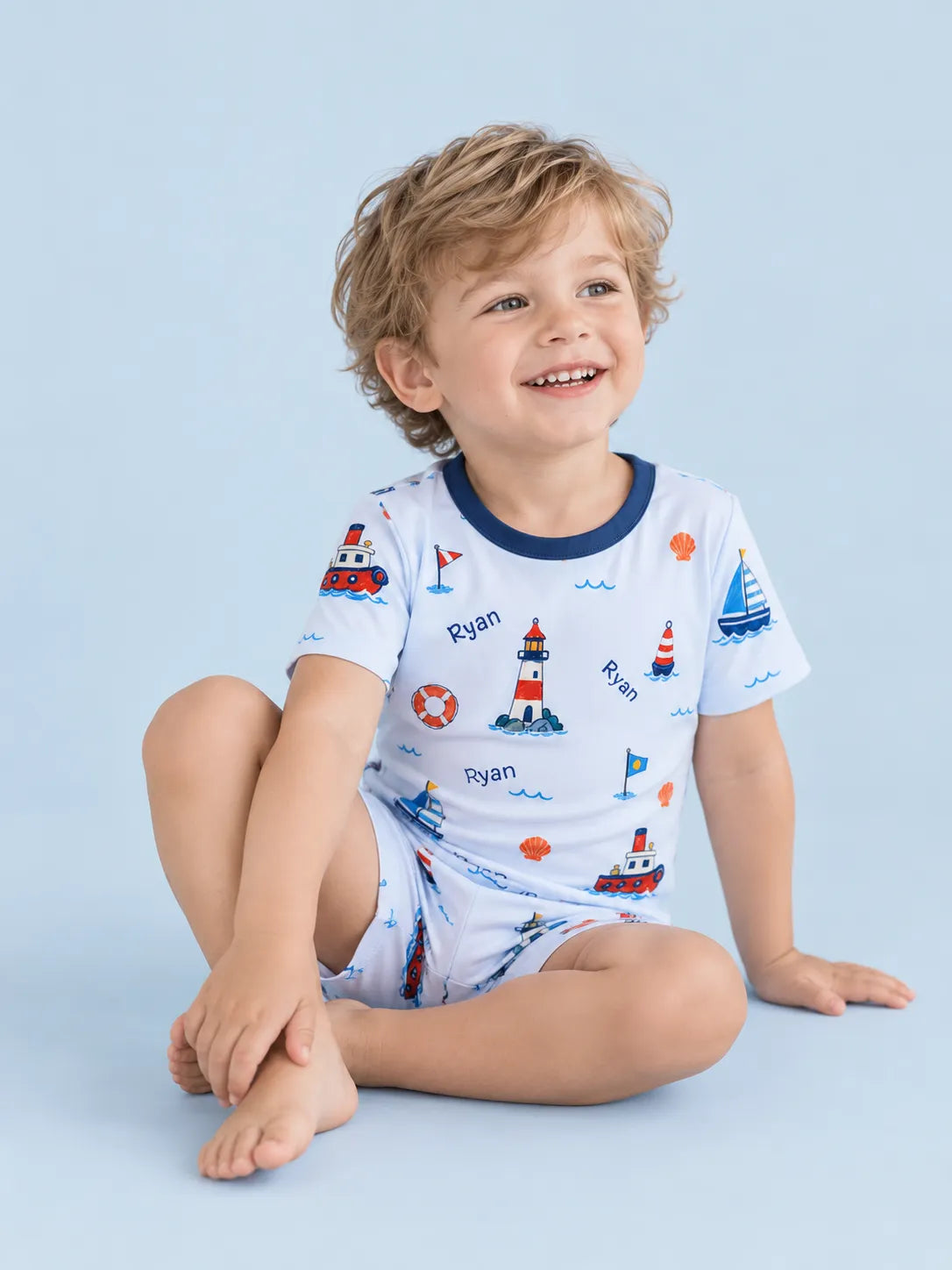 Child wearing personalized Sail Away short sleeve pajama set