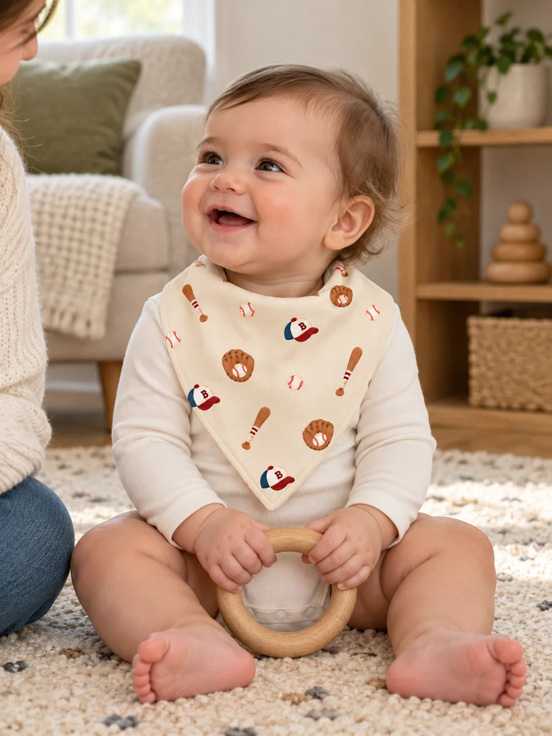 Baby wearing Little Sluggers oatmeal grey bamboo bandana bib during playtime