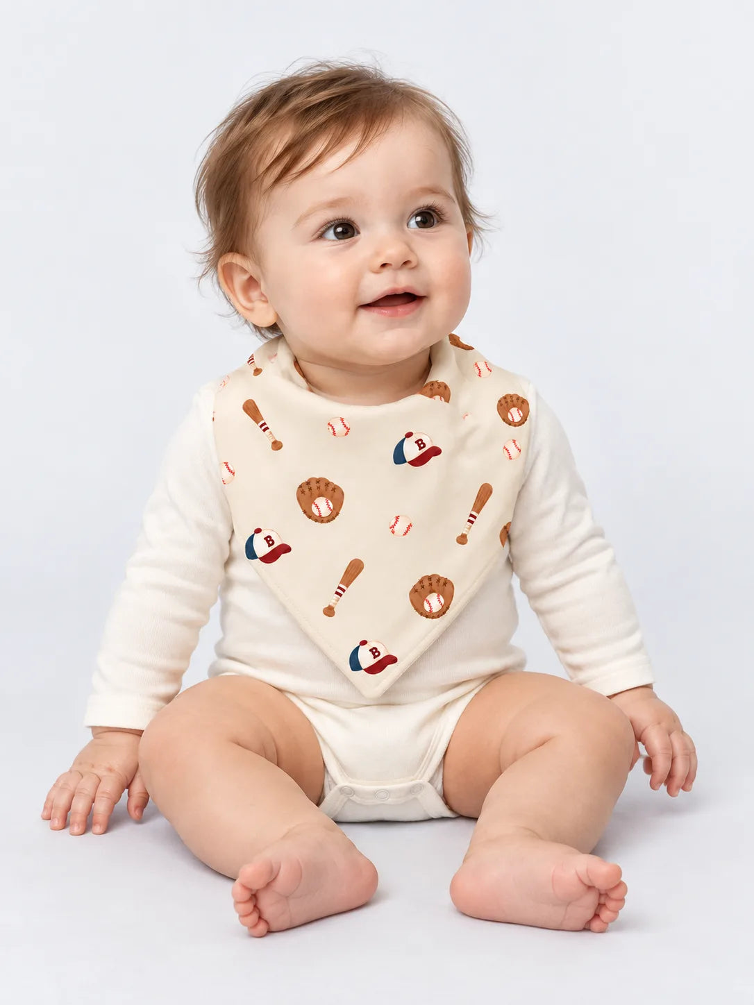 Baby wearing Little Sluggers oatmeal grey bamboo baseball bandana bib in a studio