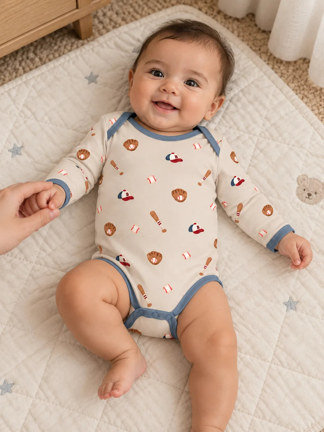 Baby enjoying playtime in Little Sluggers oatmeal grey bamboo baseball bodysuit