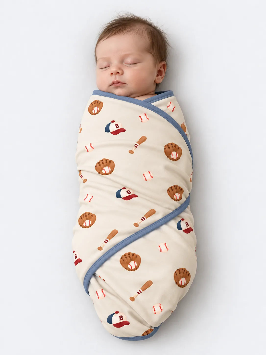 Baby lying on Little Sluggers oatmeal grey bamboo baseball blanket in a studio