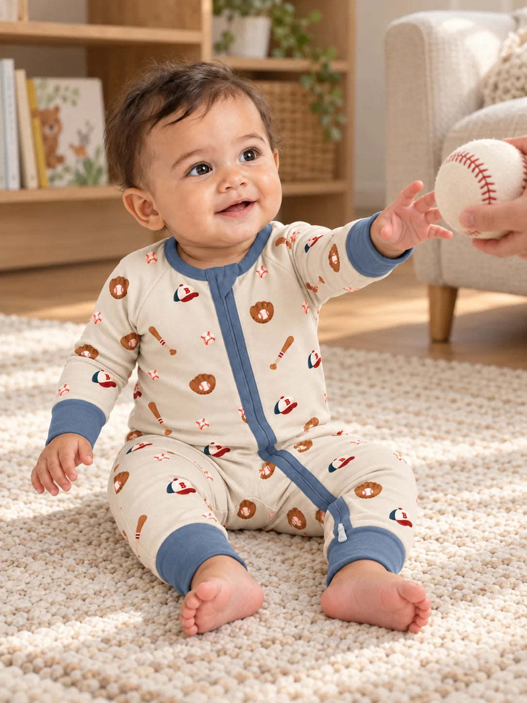 Baby relaxing at home in Mossibaby Little Sluggers oatmeal grey baseball romper