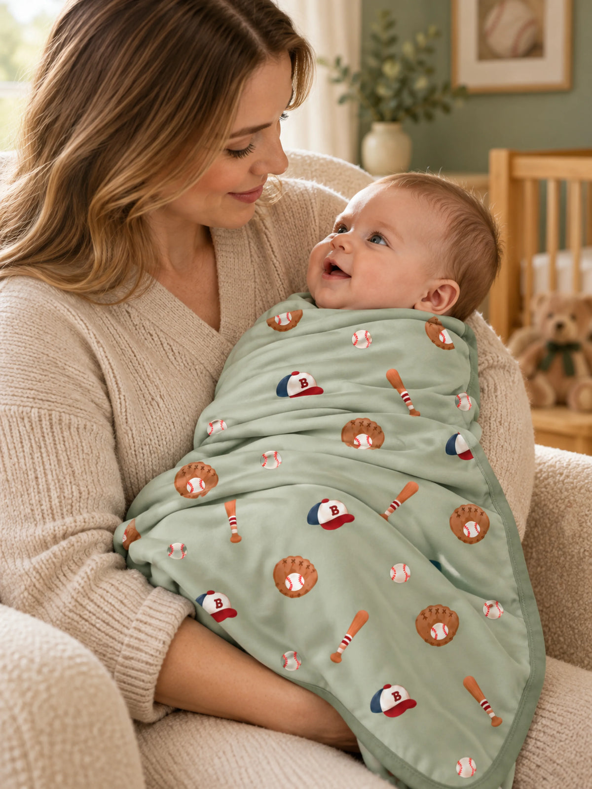 Little Sluggers sage green bamboo baby blanket displayed in a cozy nursery