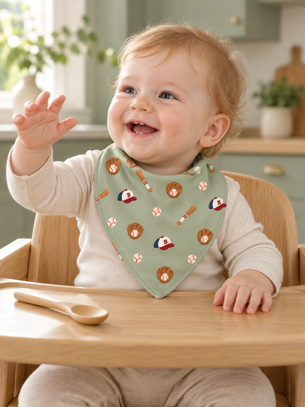 Baby wearing Little Sluggers sage green bamboo bandana bib during playtime