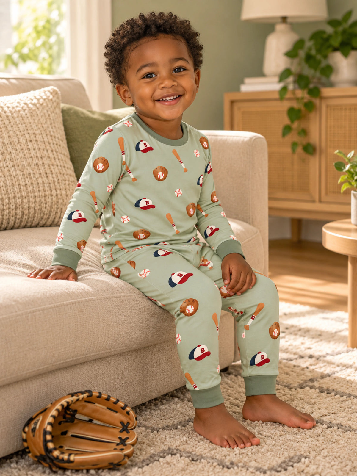 Toddler enjoying a cozy evening in Little Sluggers sage green bamboo pajamas
