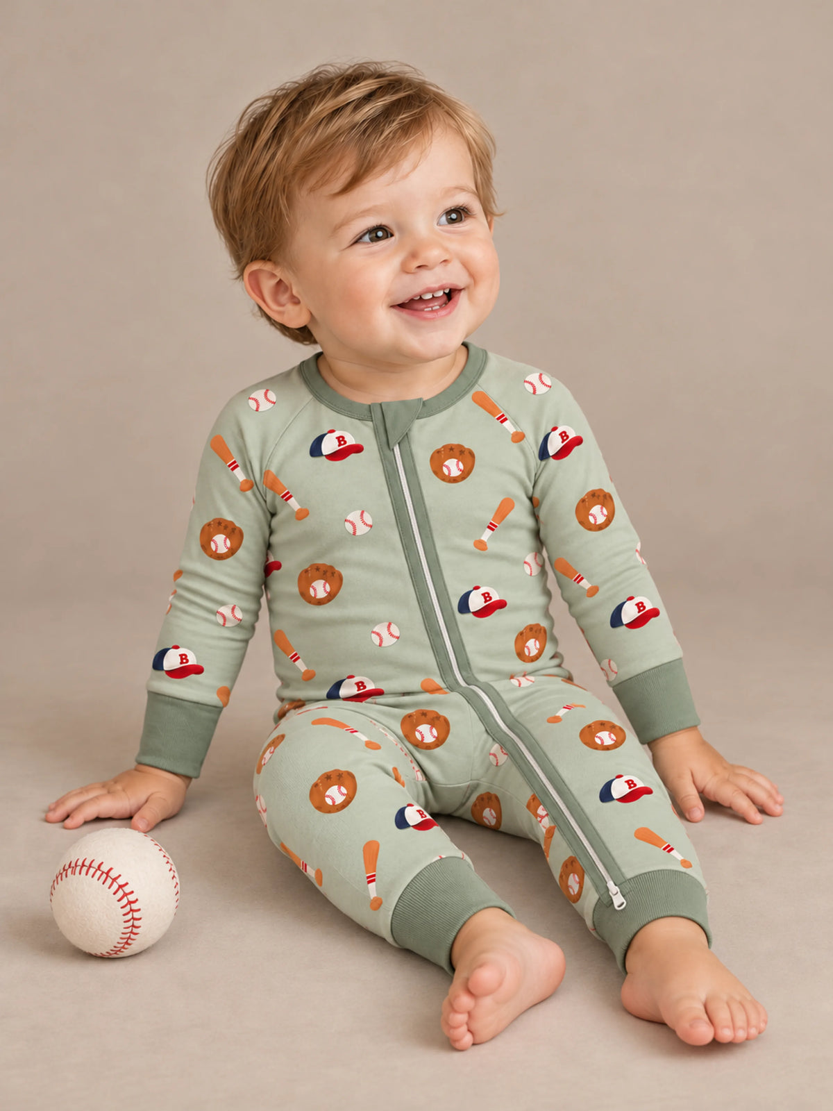 Baby wearing Little Sluggers sage green bamboo zipper romper in a studio