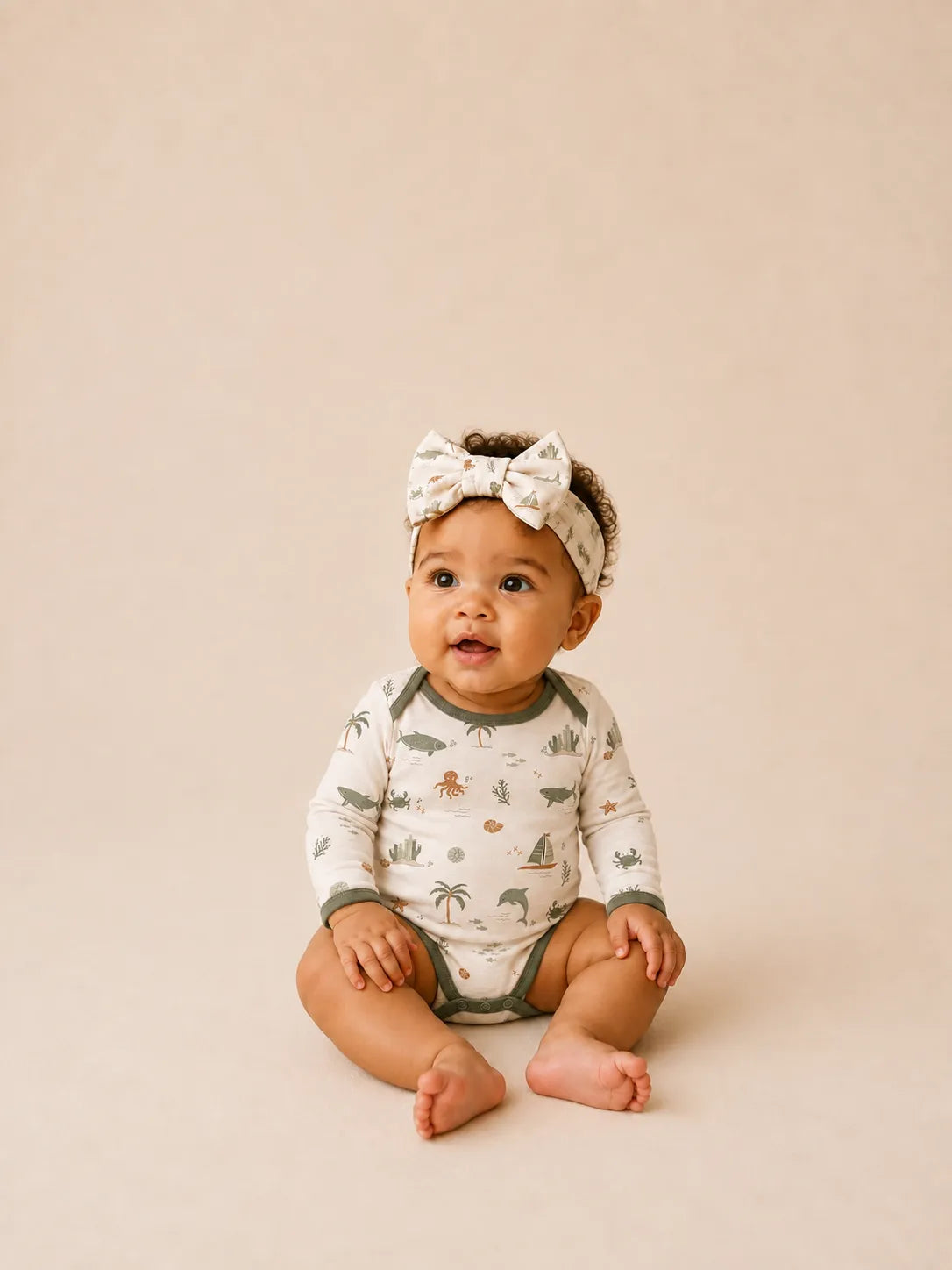 Baby wearing the Coastal Friends bow headband
