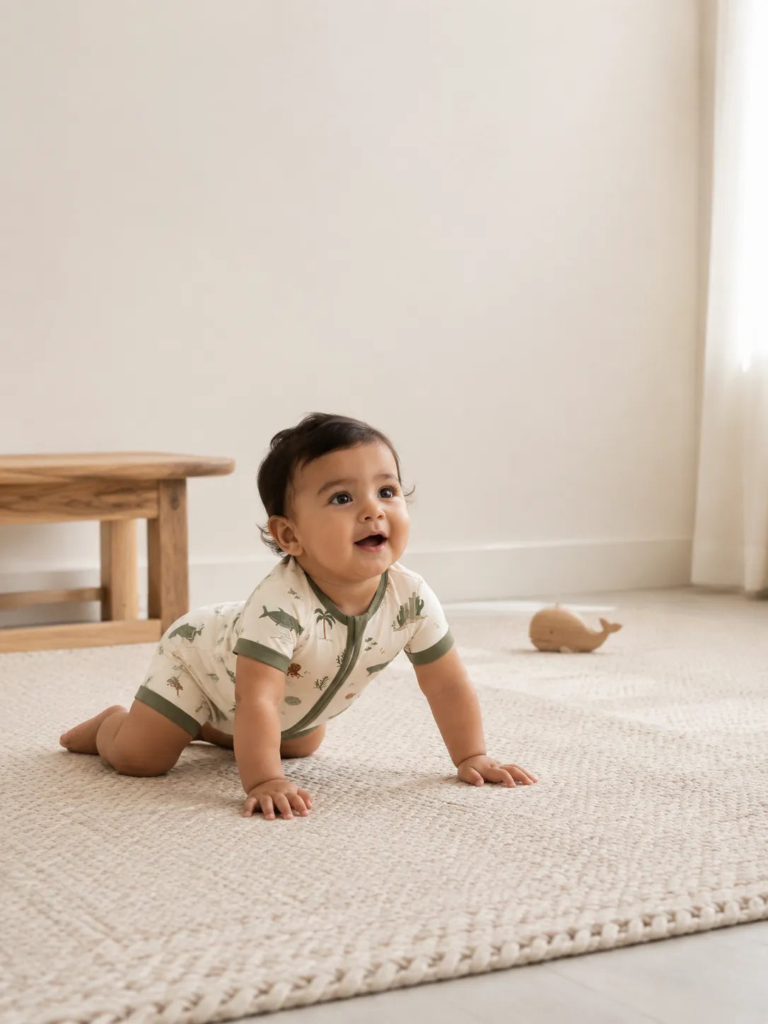 Baby playing at home in the Coastal Friends shorty romper