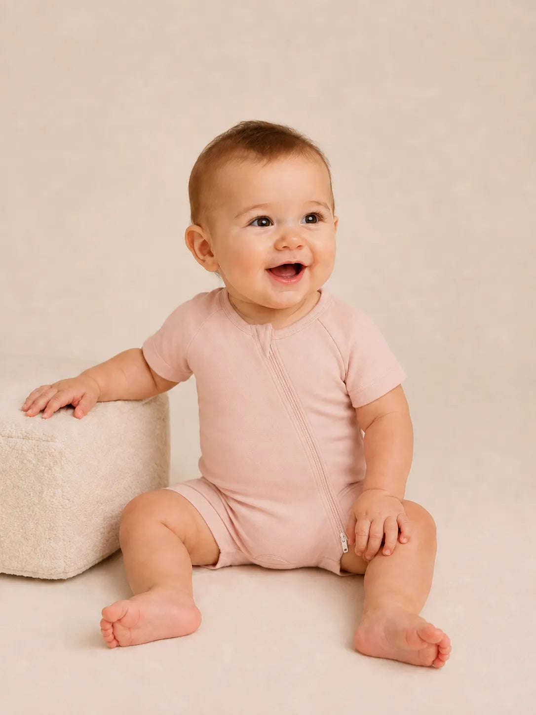 Baby wearing Blush Pink bamboo shorty romper in studio - MossiBaby