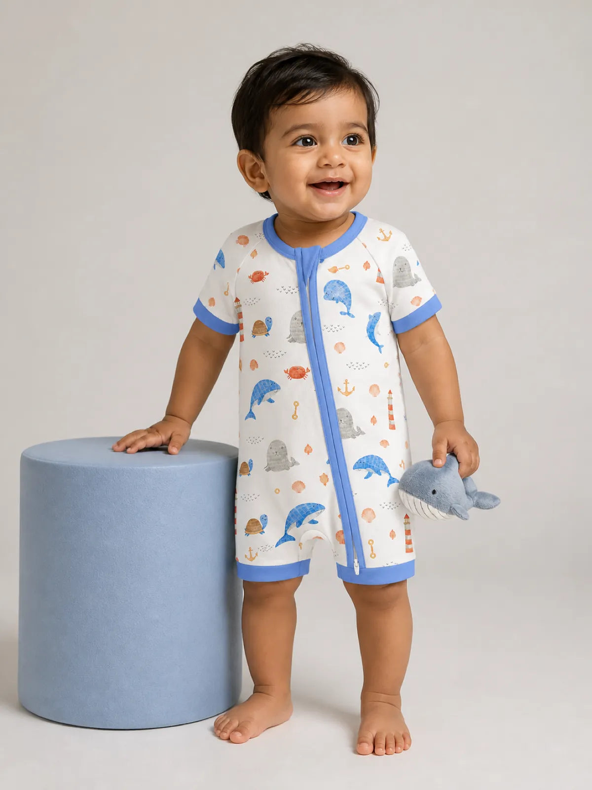 Baby wearing the Whale Harbor bamboo shorty romper