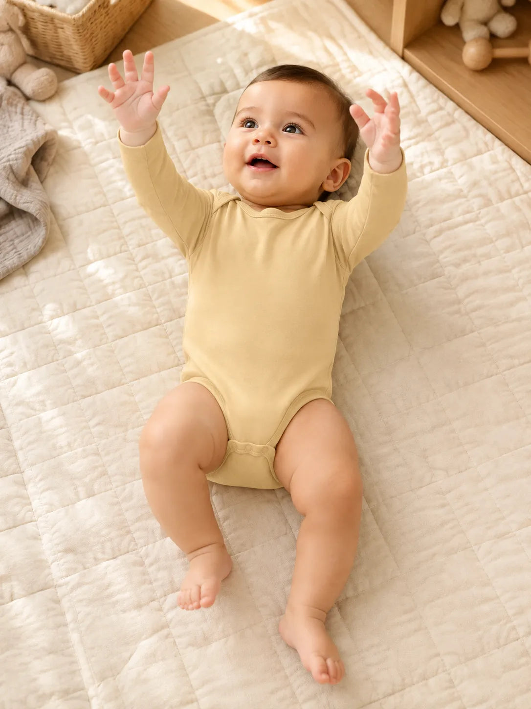 Baby in Buttercream bamboo long sleeve bodysuit in an everyday lifestyle setting - MossiBaby