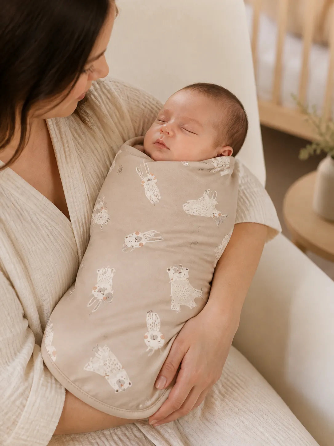 Baby cuddled in the Fox Meadow bamboo swaddle blanket at home