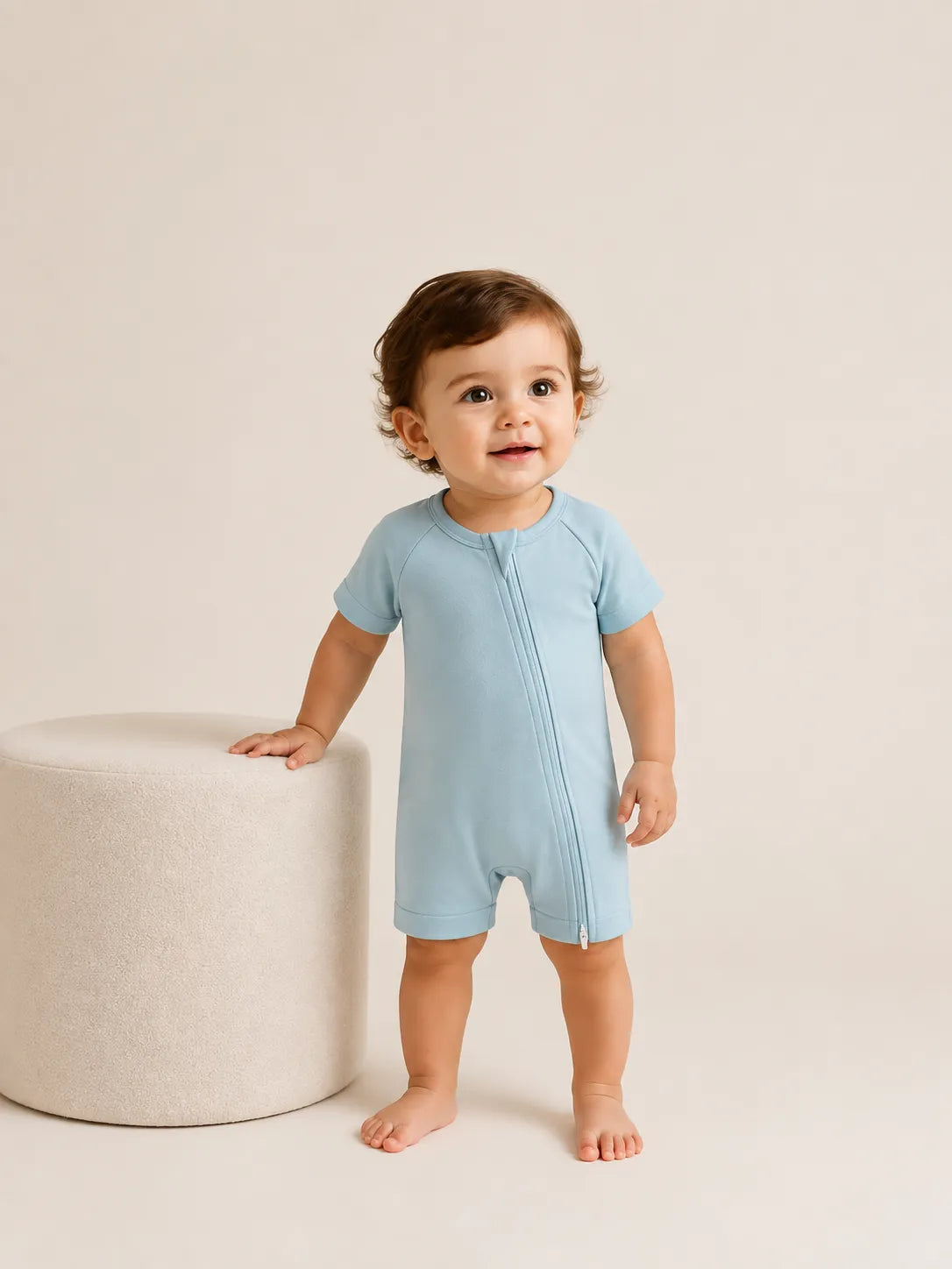 Baby wearing Dusty Blue bamboo shorty romper in studio - MossiBaby
