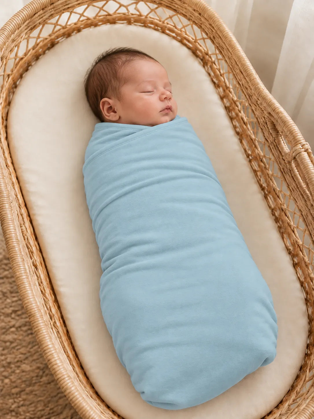 Baby wrapped in Dusty Blue bamboo swaddle blanket in studio - MossiBaby