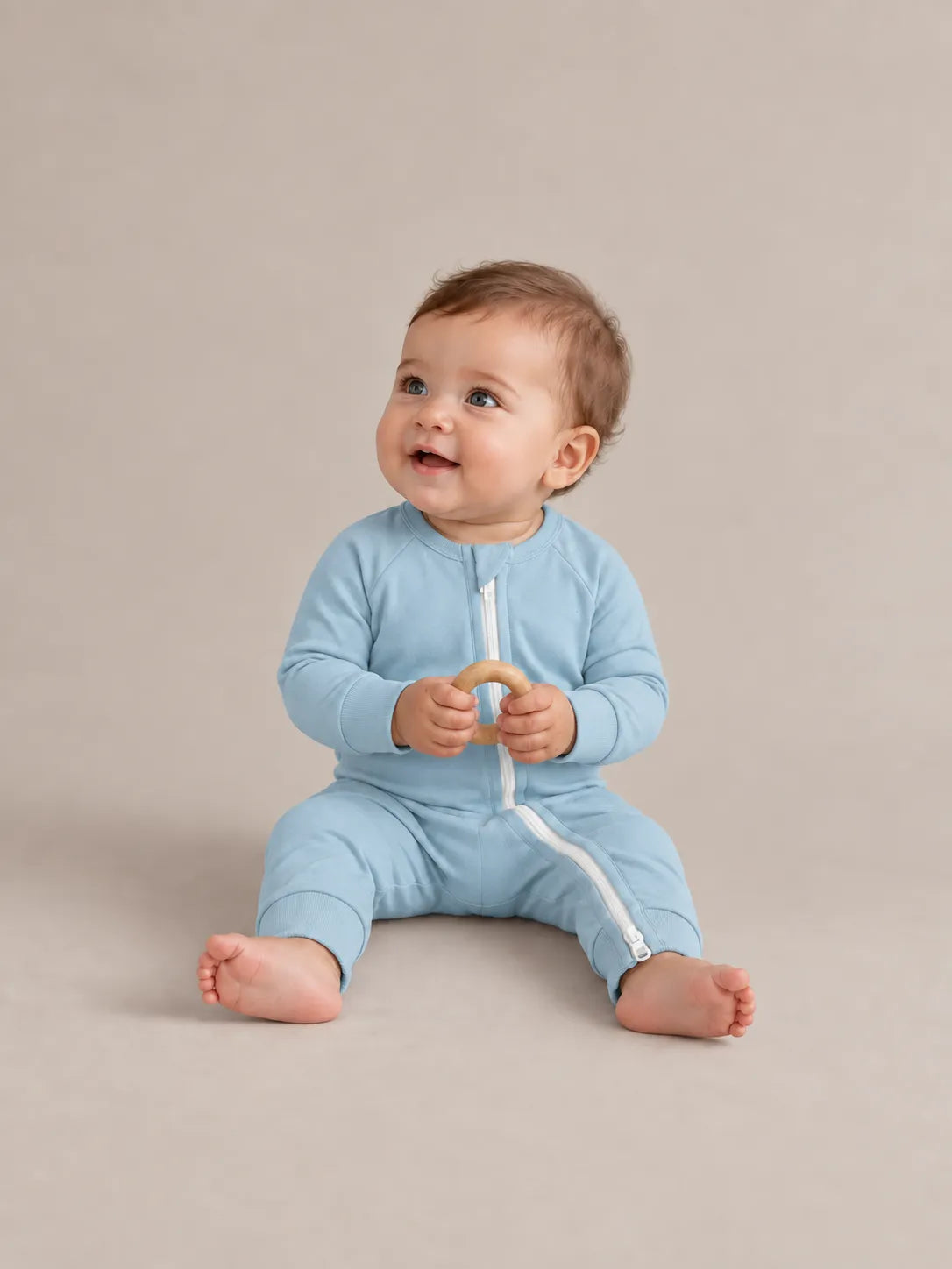 Baby wearing Dusty Blue bamboo zipper romper in studio - MossiBaby