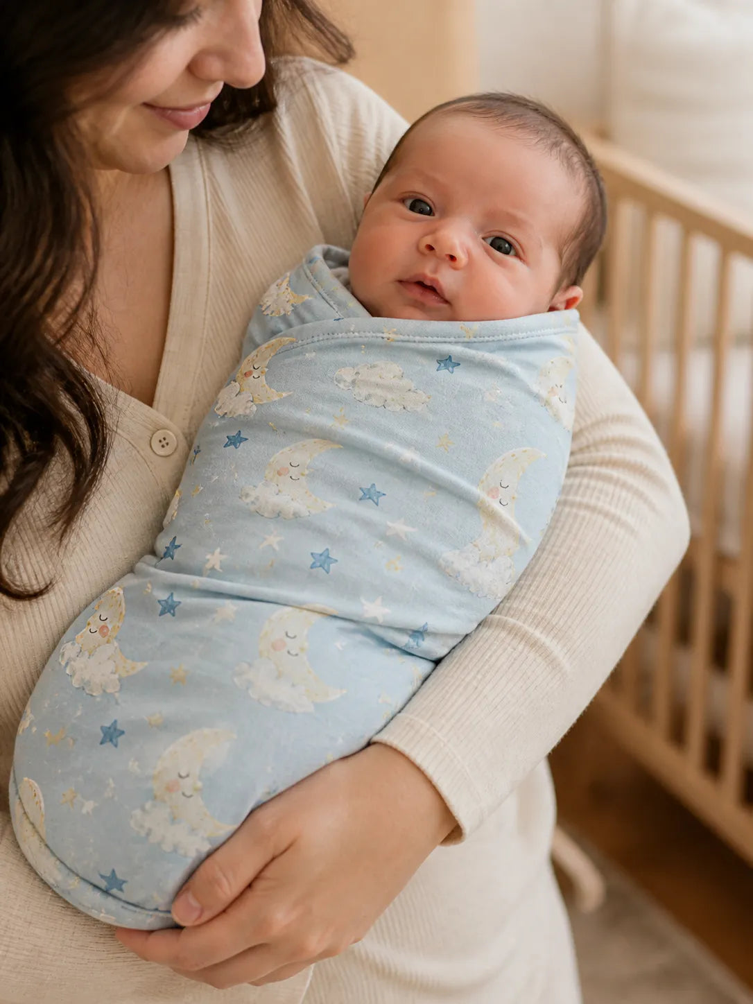 Baby wrapped in the Moonlit Dreams bamboo swaddle blanket