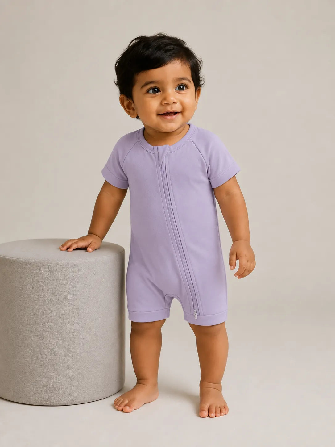 Baby wearing Lavender bamboo shorty romper in studio - MossiBaby