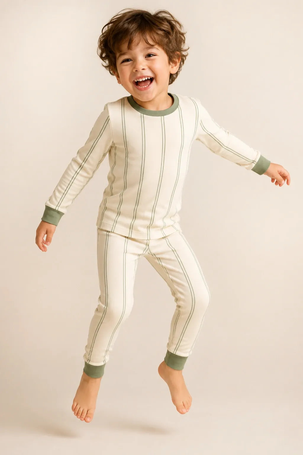 Child wearing the Sage Stripe long sleeve pajama set