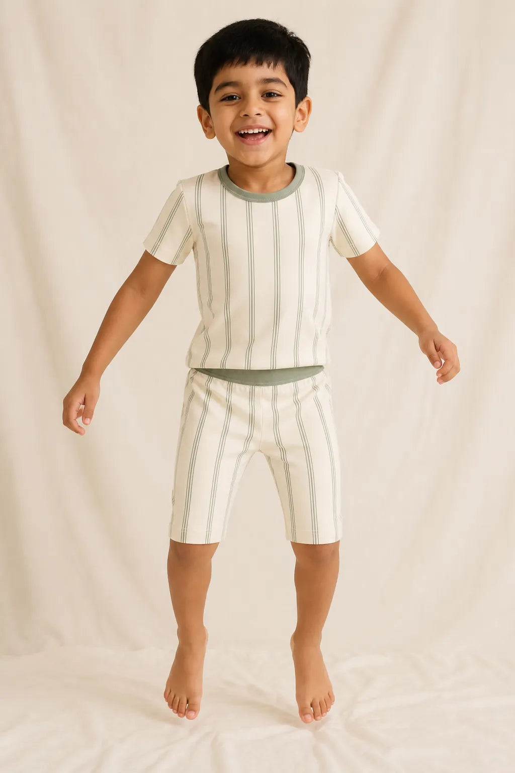 Child wearing the Sage Stripe short sleeve pajama set