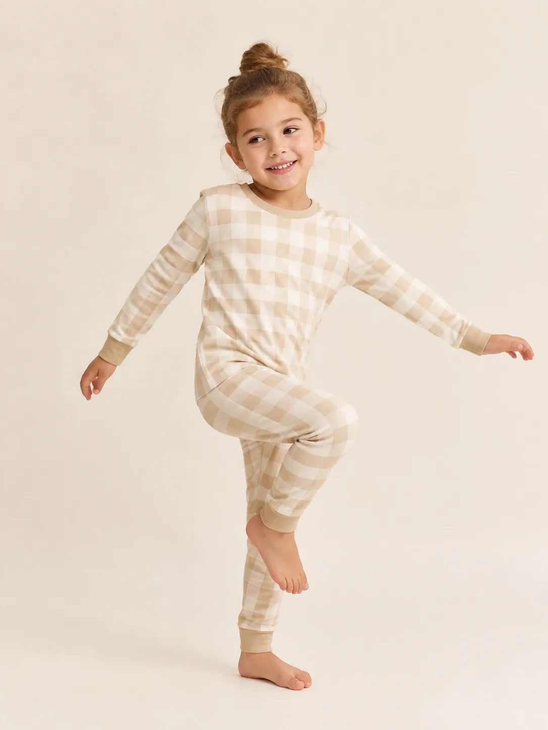 Child wearing the Oat Gingham long sleeve pajama set