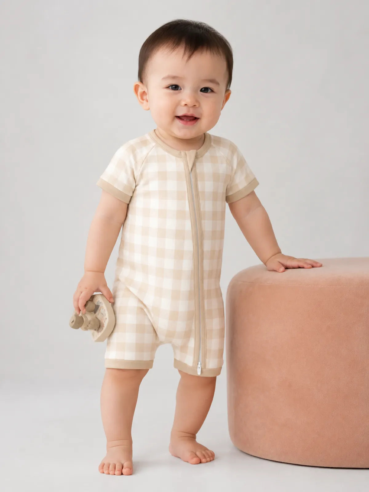 Baby wearing the Oat Gingham bamboo shorty romper