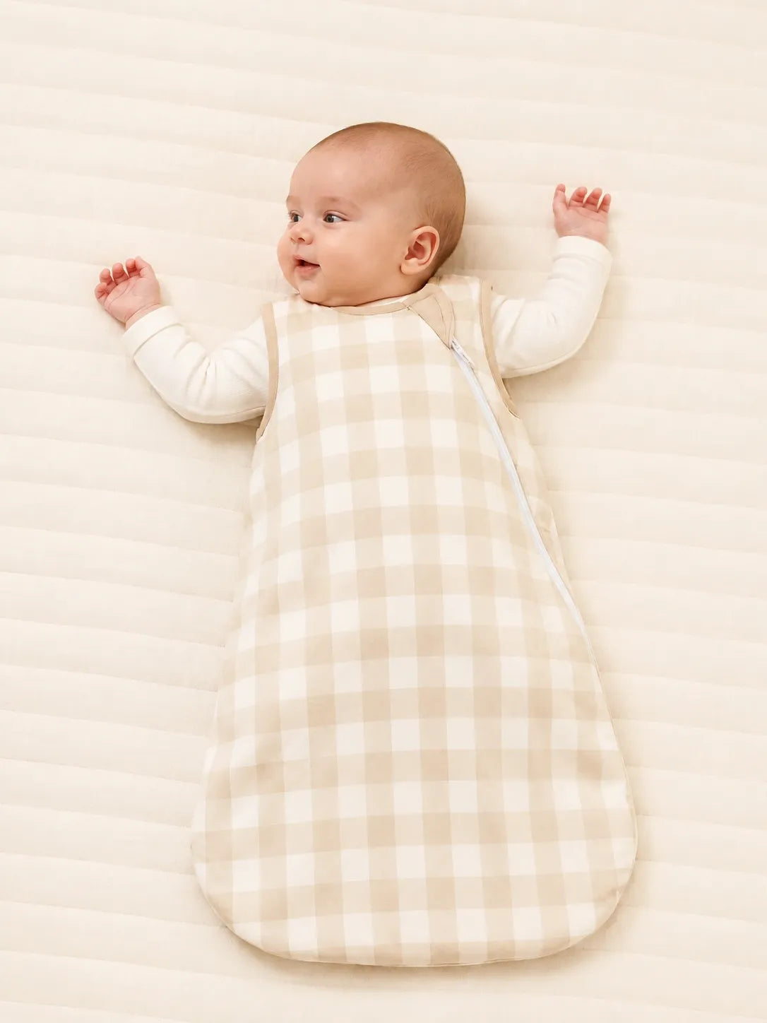 Baby wearing the Oat Gingham bamboo sleep bag