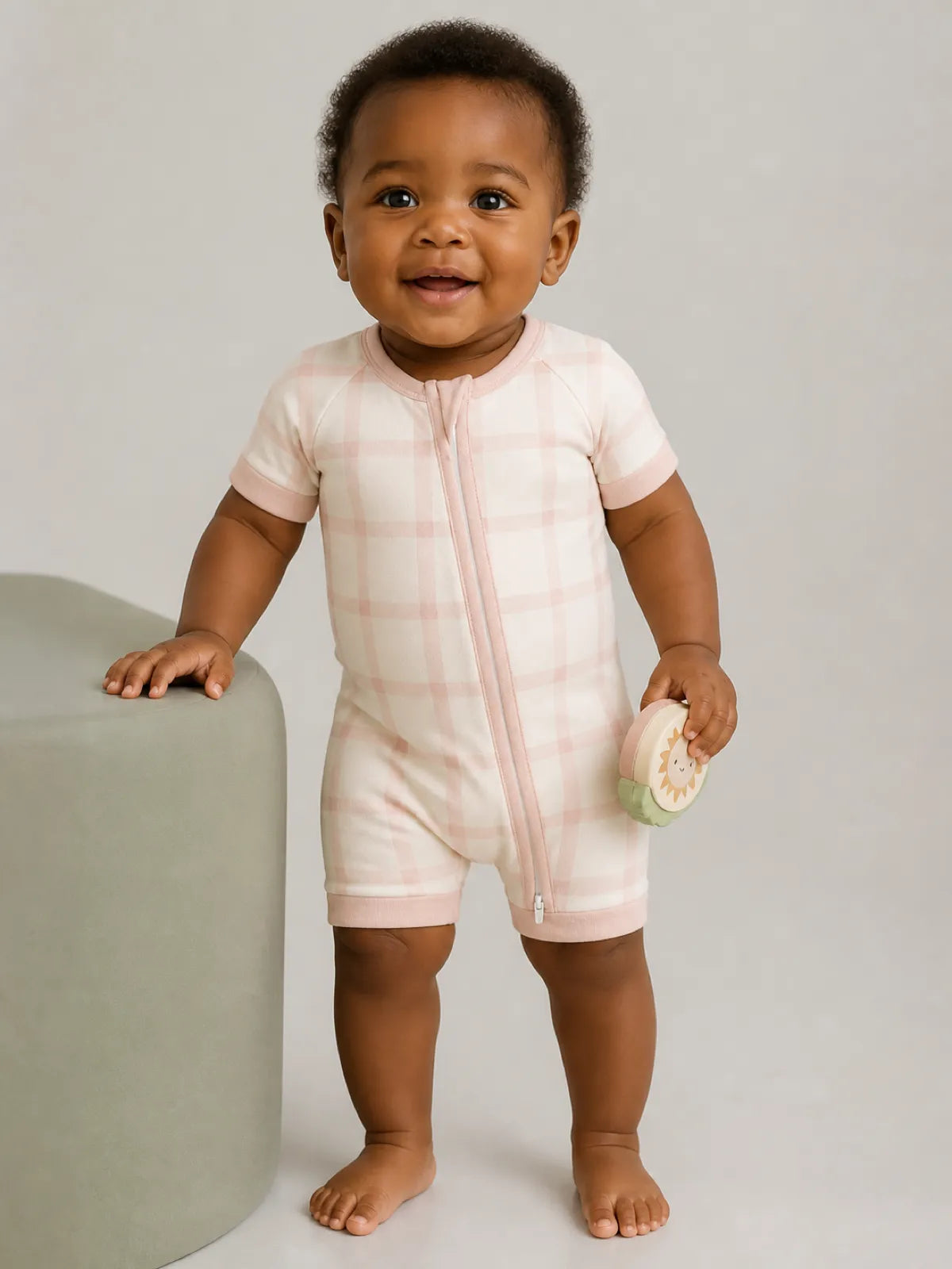 Baby wearing the Blush Plaid bamboo shorty romper
