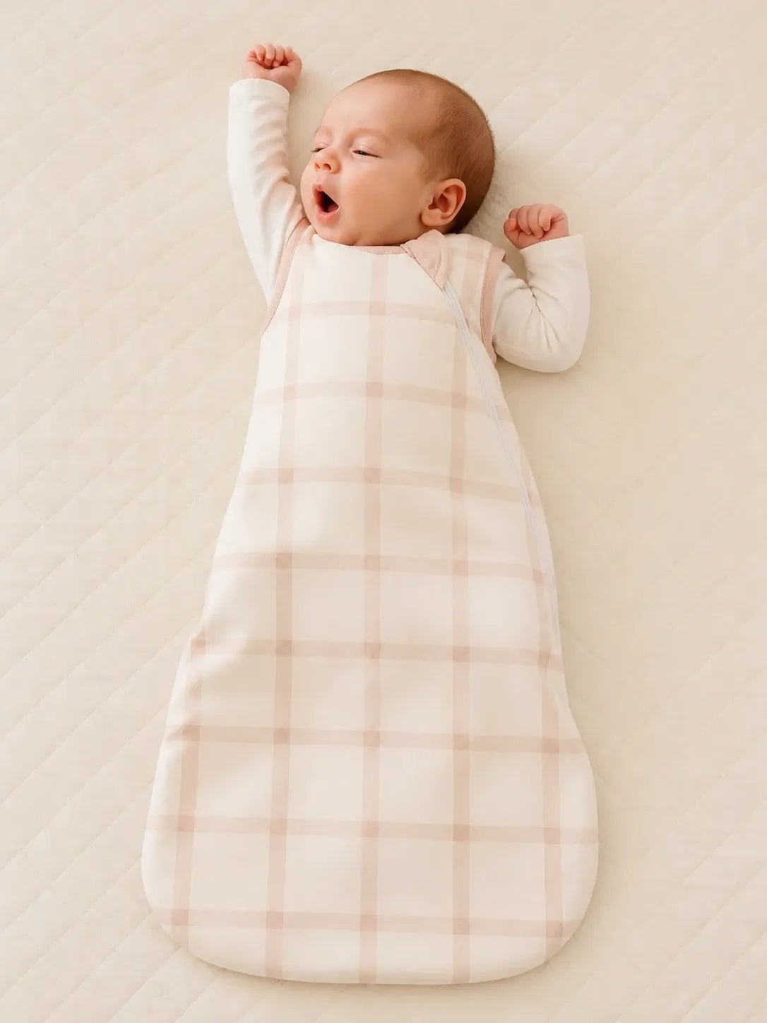 Baby wearing the Blush Plaid bamboo sleep bag