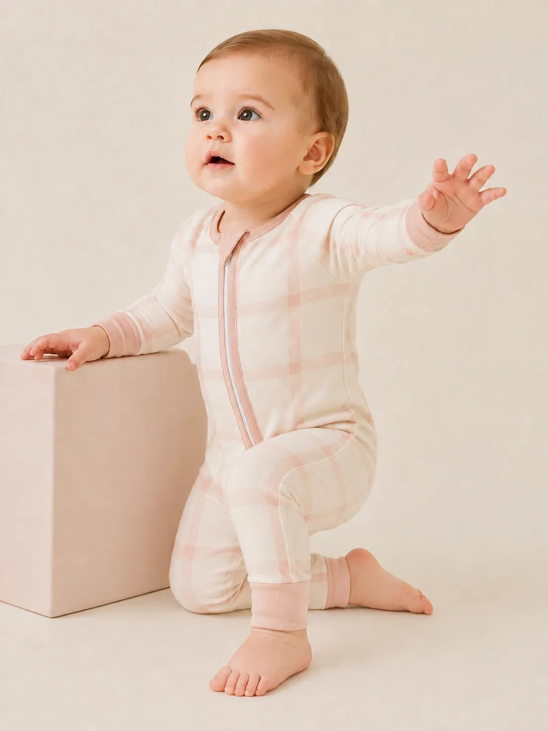 Baby wearing the Blush Plaid bamboo zipper romper