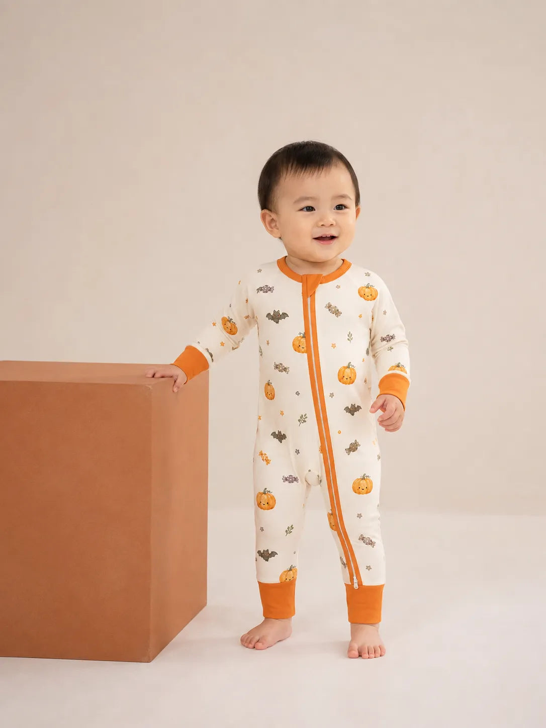 Baby wearing the Pumpkin Treats bamboo zipper romper