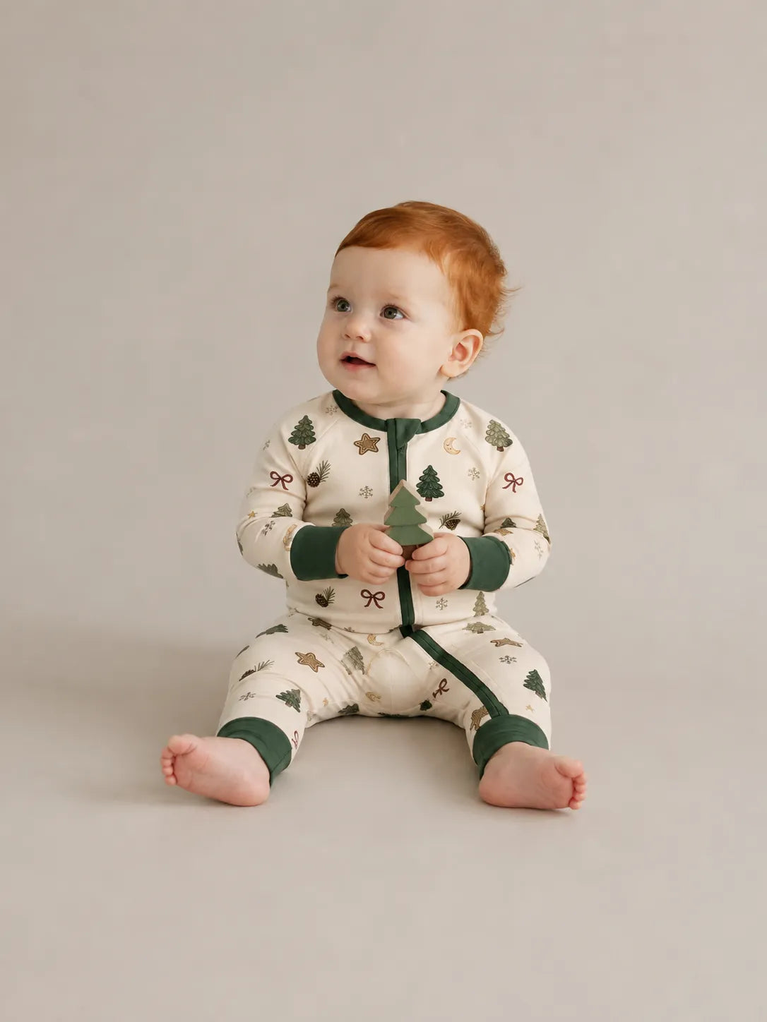 Baby wearing the Christmas Forest bamboo zipper romper