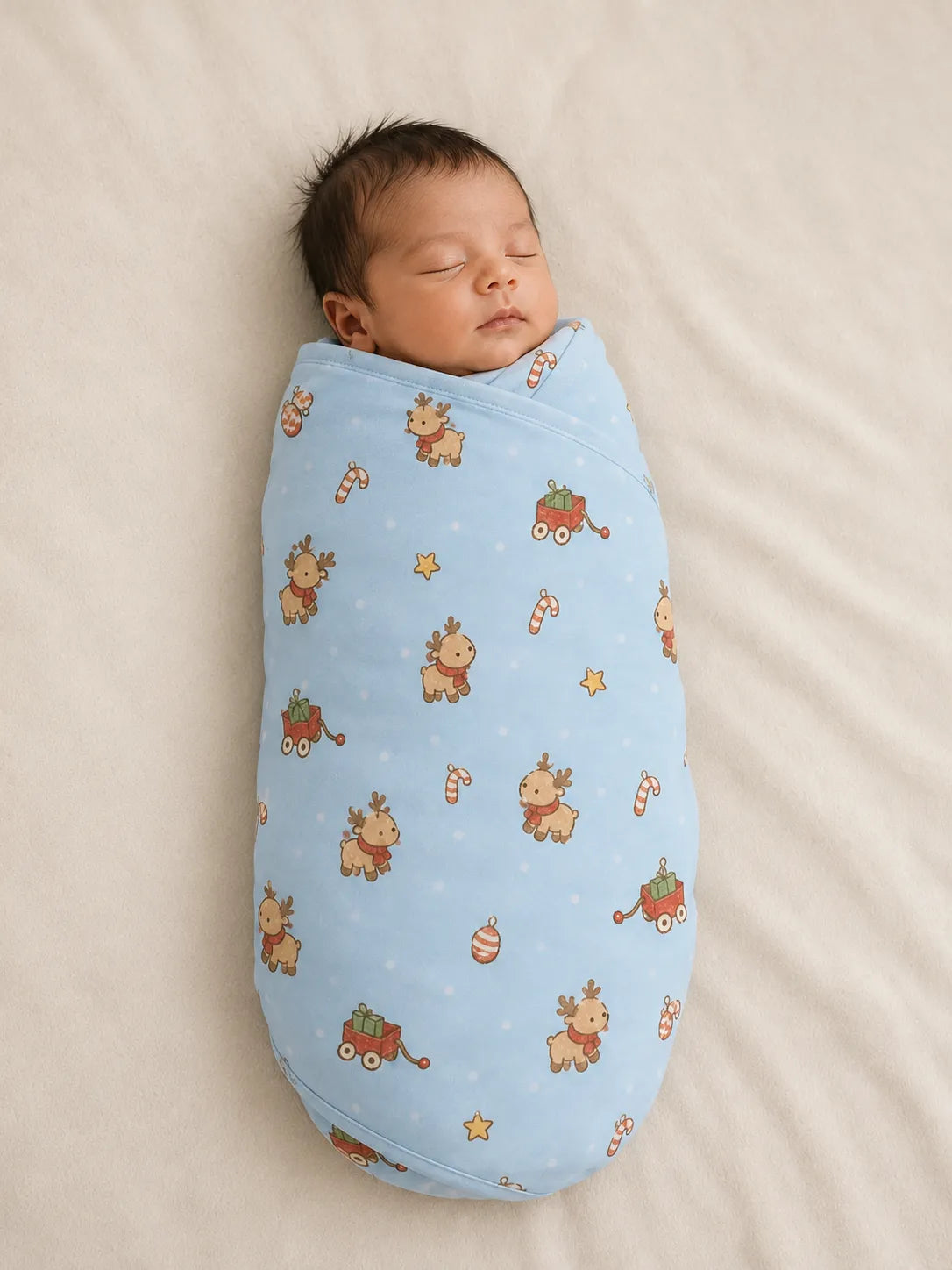 Baby wrapped in the Reindeer Ride bamboo swaddle blanket