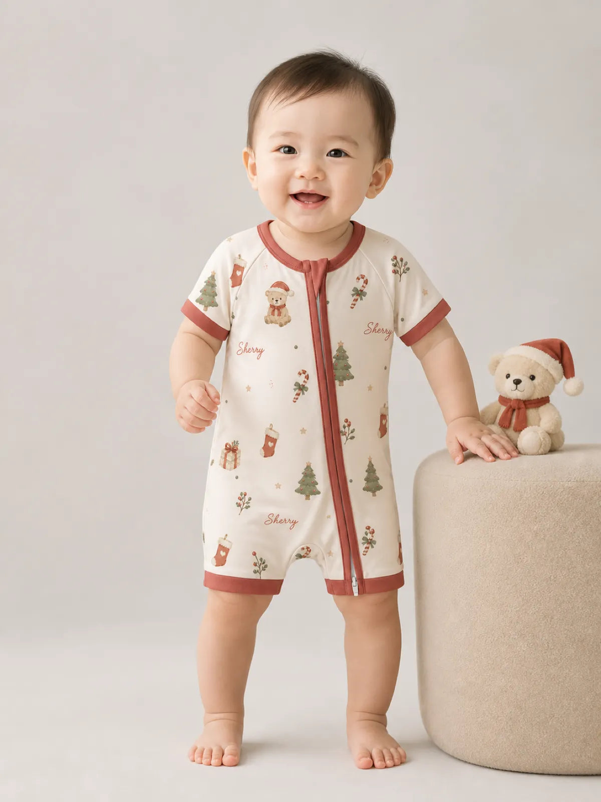 Baby playing at home in the Christmas Teddy shorty romper