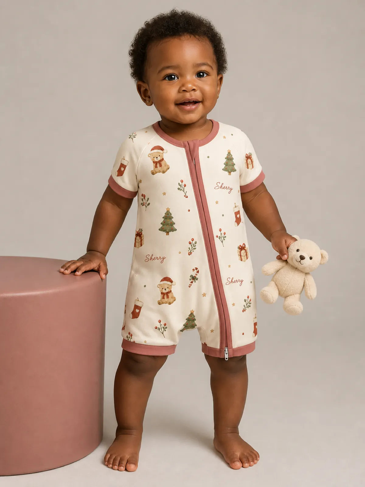 Baby playing at home in the Christmas Teddy shorty romper