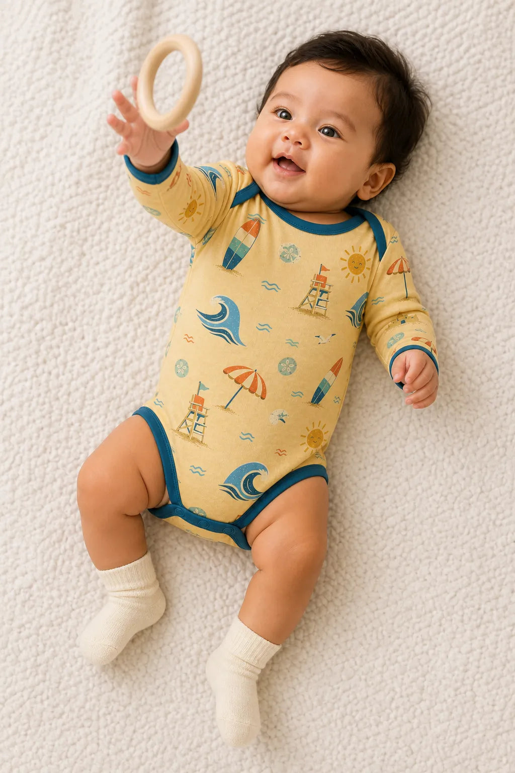 Baby playing comfortably in the Beach Day bamboo bodysuit