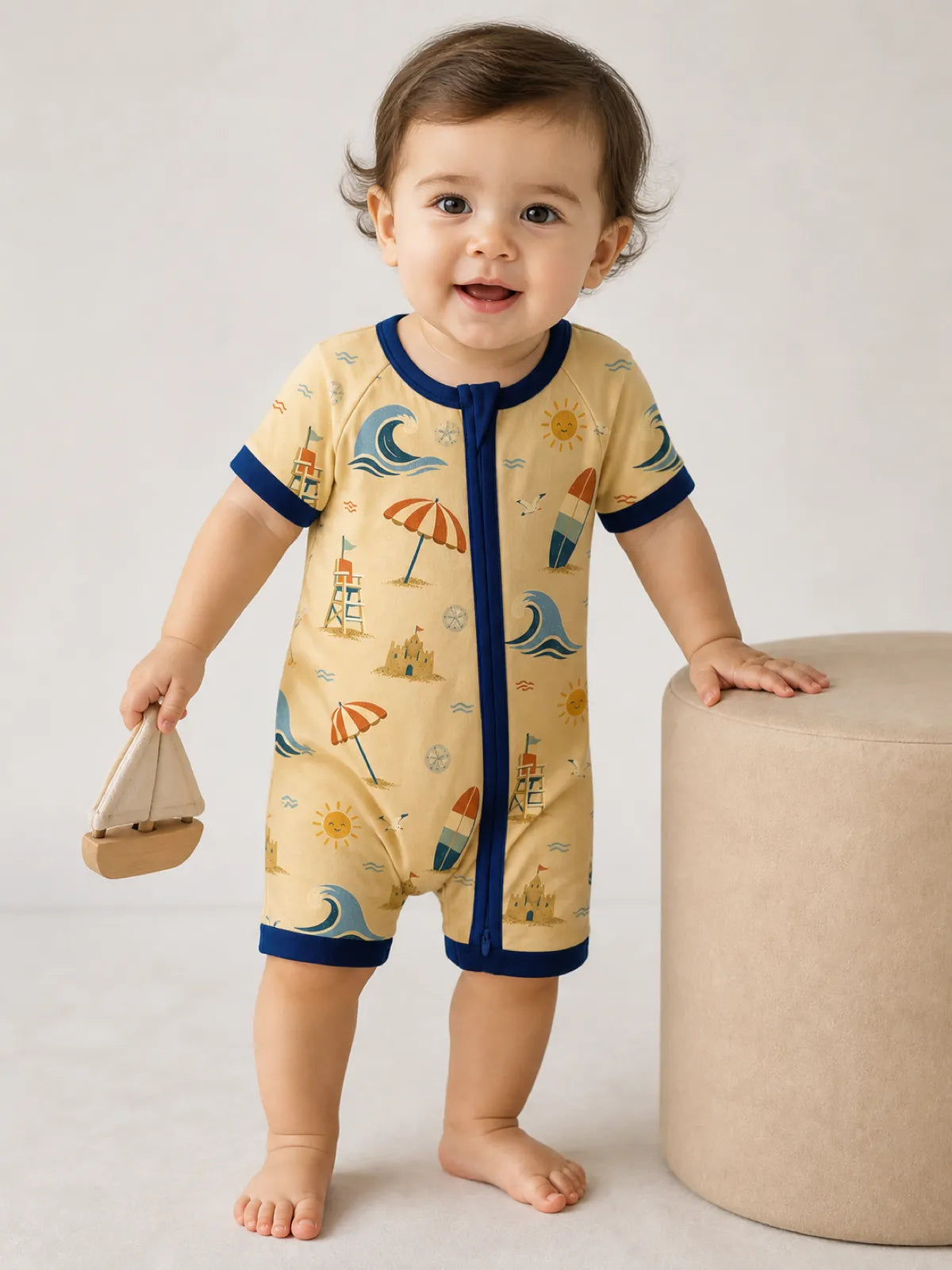 Baby playing at home in the Beach Day shorty romper