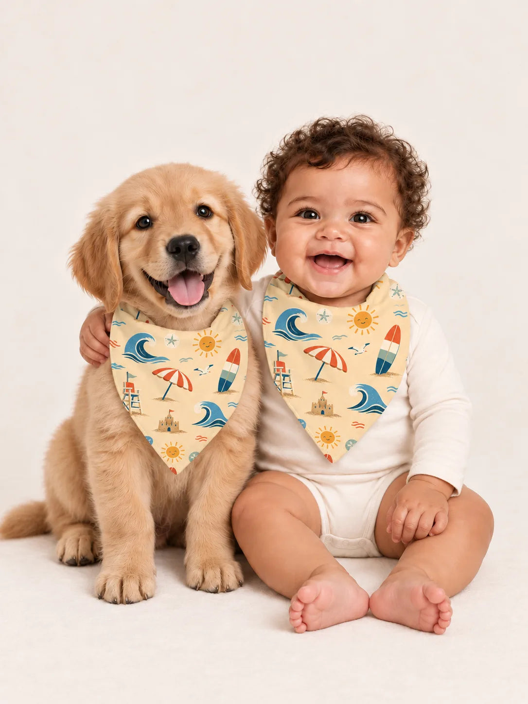 Baby and Golden Retriever puppy wearing matching MossiBaby Beach Day bandana bibs