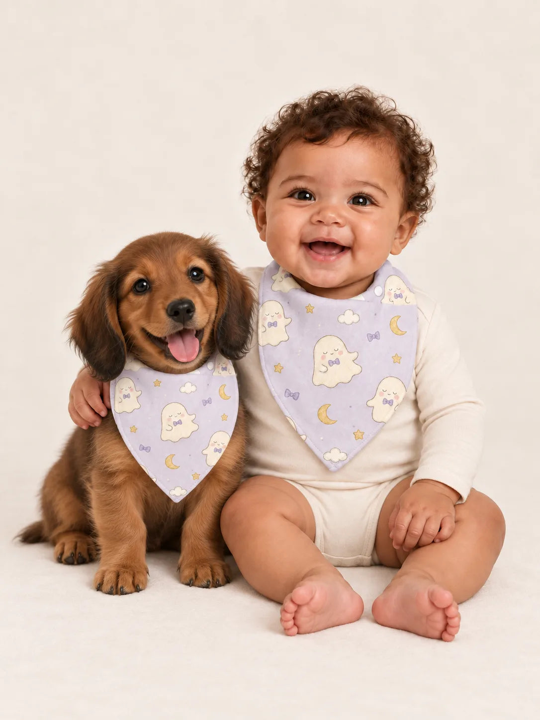 Baby and Miniature Dachshund puppy wearing matching MossiBaby Boo & Moon bandana bibs