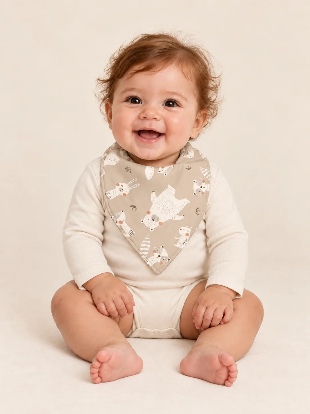 Baby wearing the MossiBaby Fox Meadow bandana bib with an ivory long-sleeve bodysuit