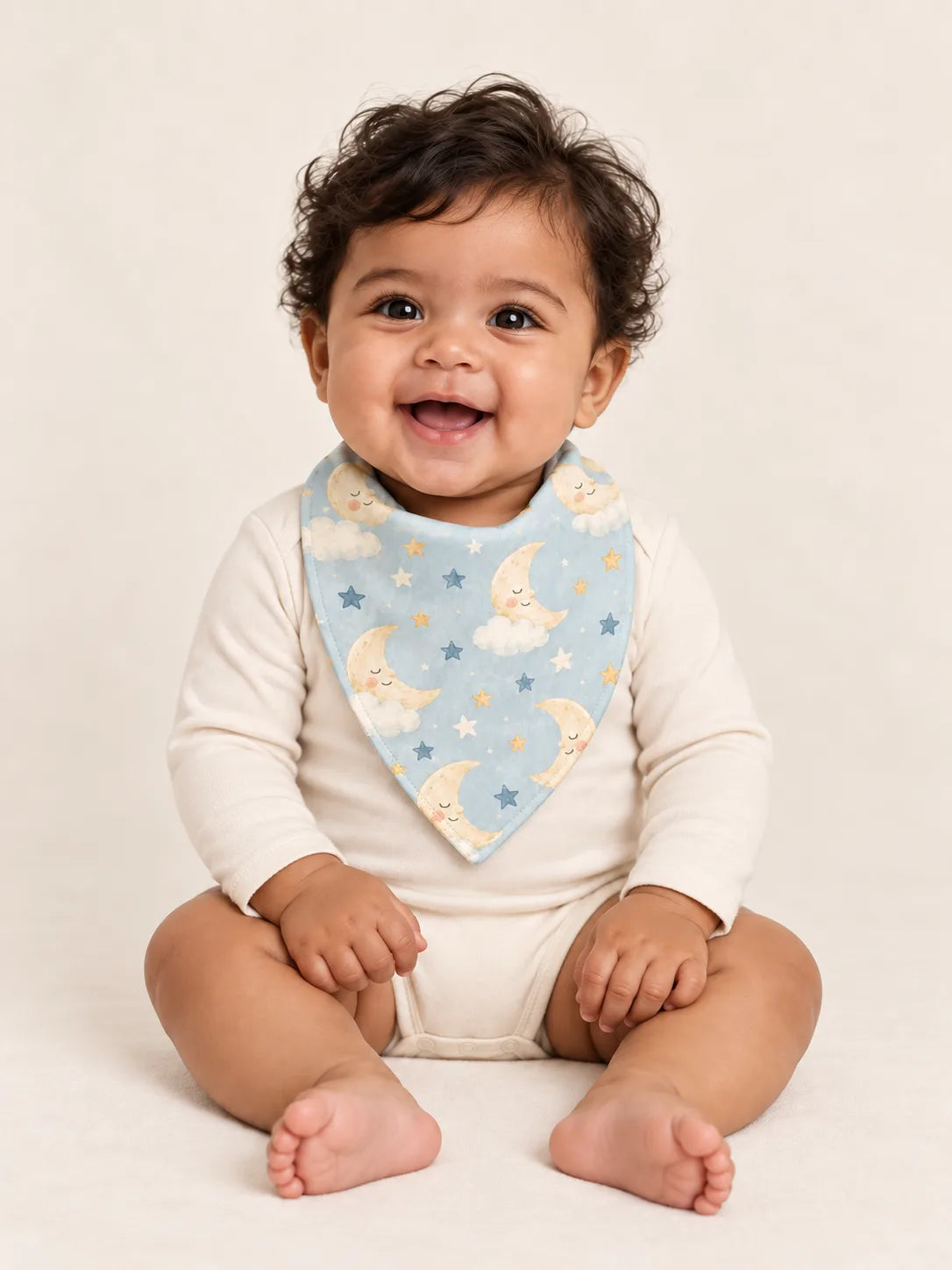 Baby wearing the MossiBaby Moonlit Dreams bandana bib with an ivory long-sleeve bodysuit
