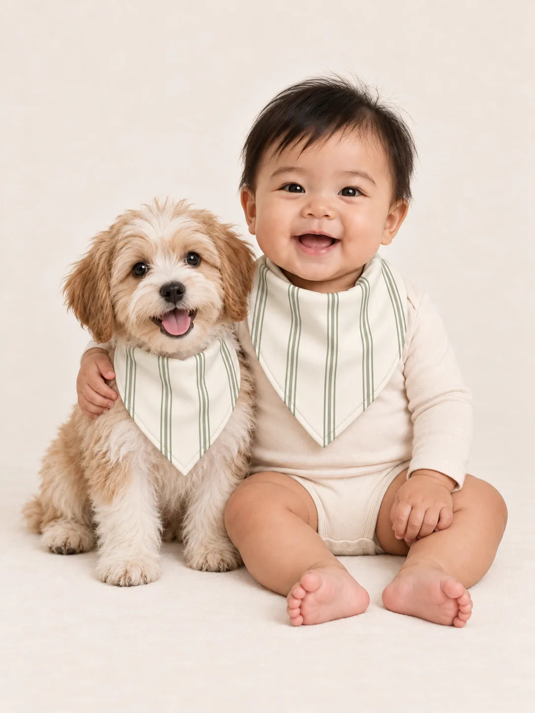 Baby and Havanese puppy wearing matching MossiBaby Sage Stripe bandana bibs