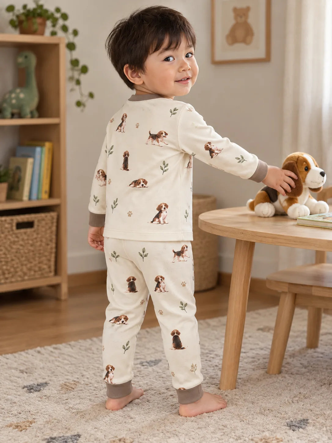 Child wearing the MossiBaby beagle buddies long sleeve pajama set in an indoor lifestyle scene
