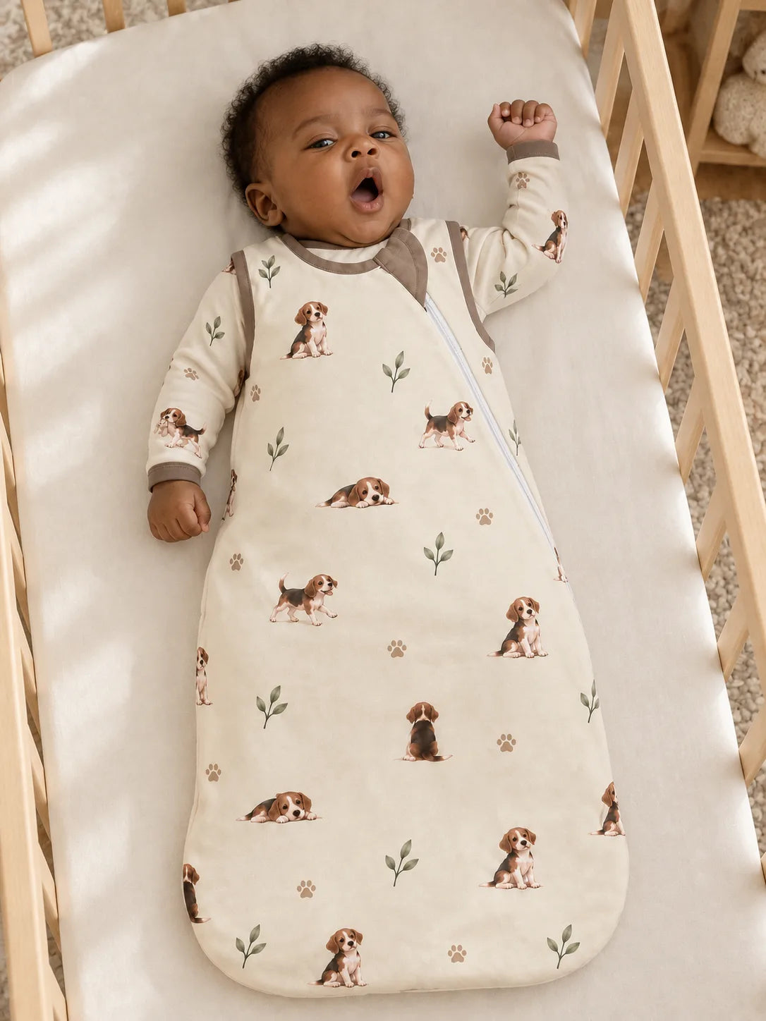 Baby wearing the MossiBaby beagle buddies sleep bag in an indoor lifestyle scene