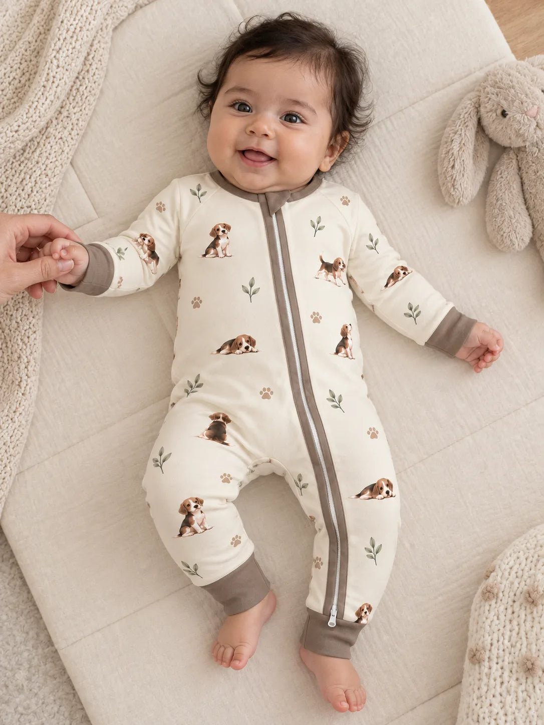 Baby wearing the MossiBaby beagle buddies zipper romper in an indoor lifestyle scene