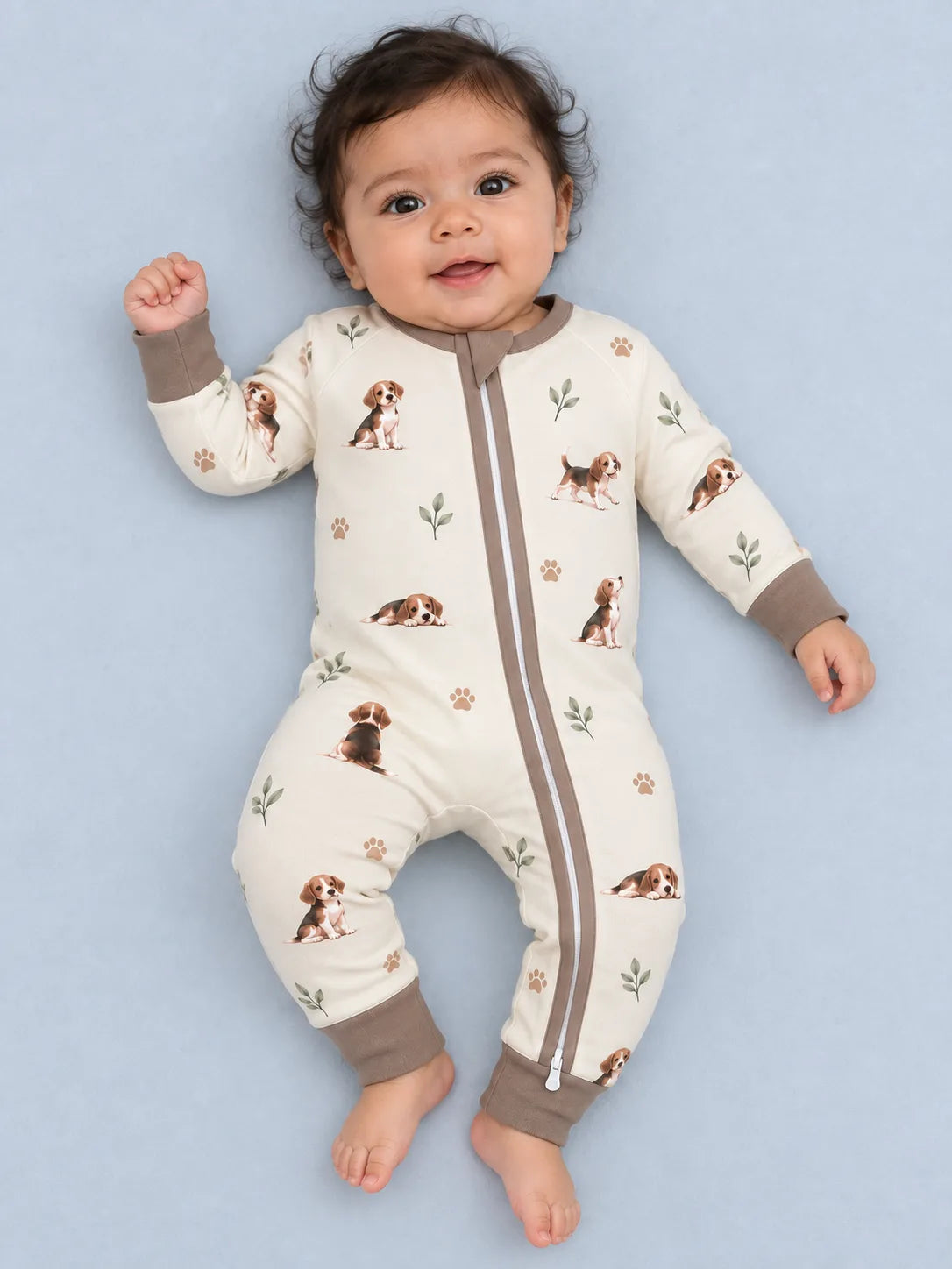 Baby wearing the MossiBaby beagle buddies zipper romper against a pale studio backdrop