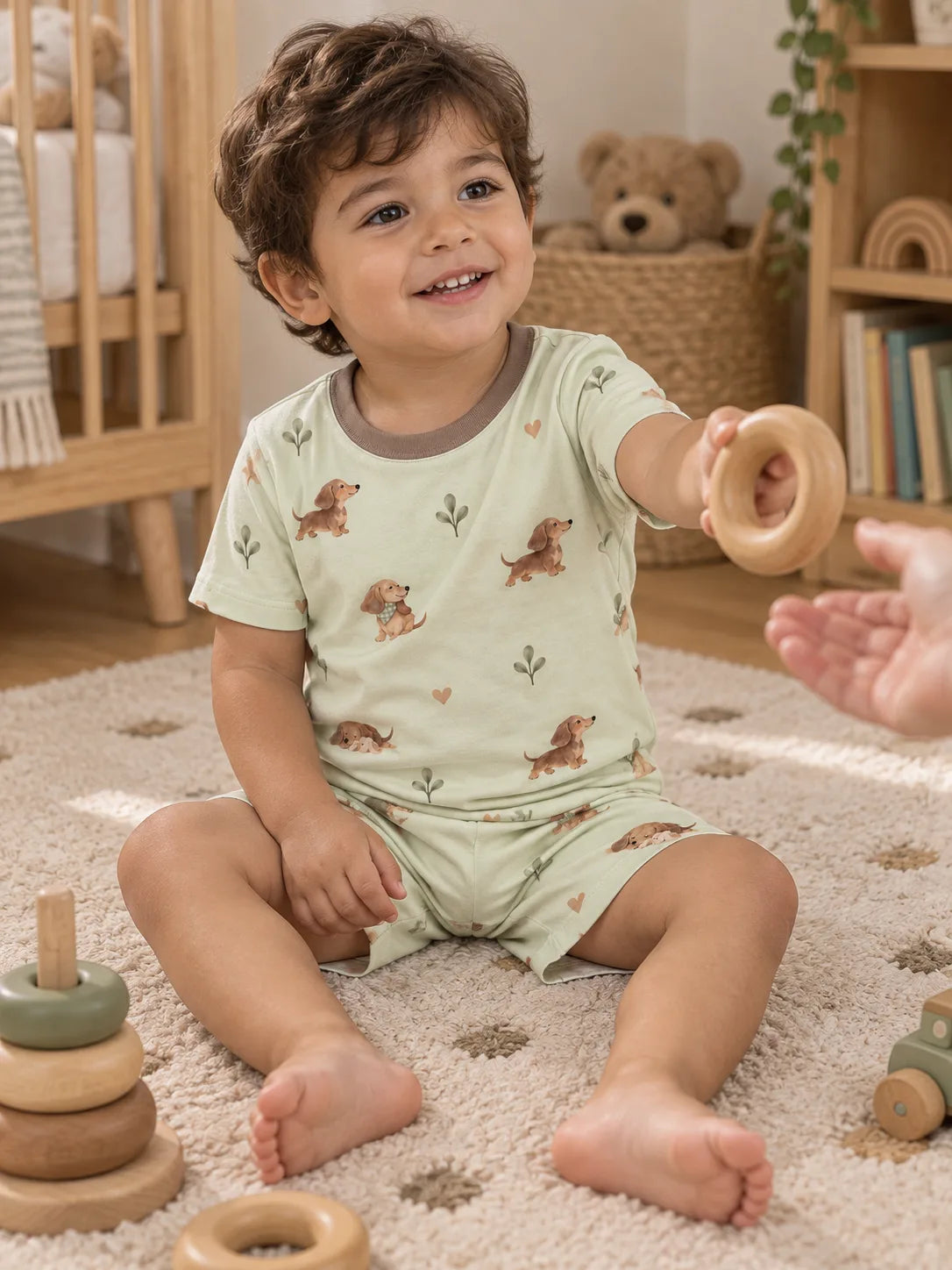 Child wearing the MossiBaby dachshund meadow short sleeve pajama set in an indoor lifestyle scene