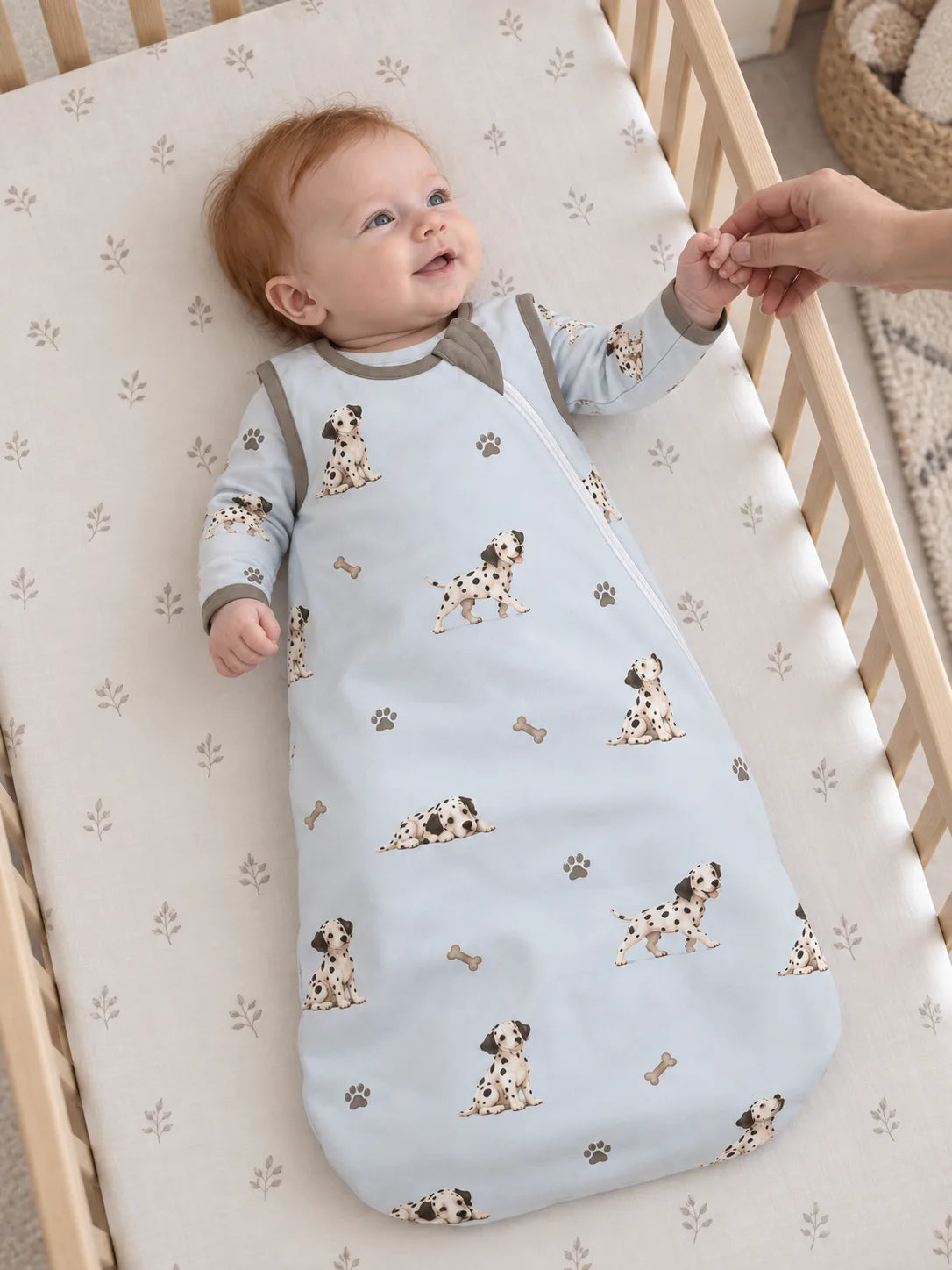 Baby wearing the MossiBaby dalmatian days sleep bag in an indoor lifestyle scene