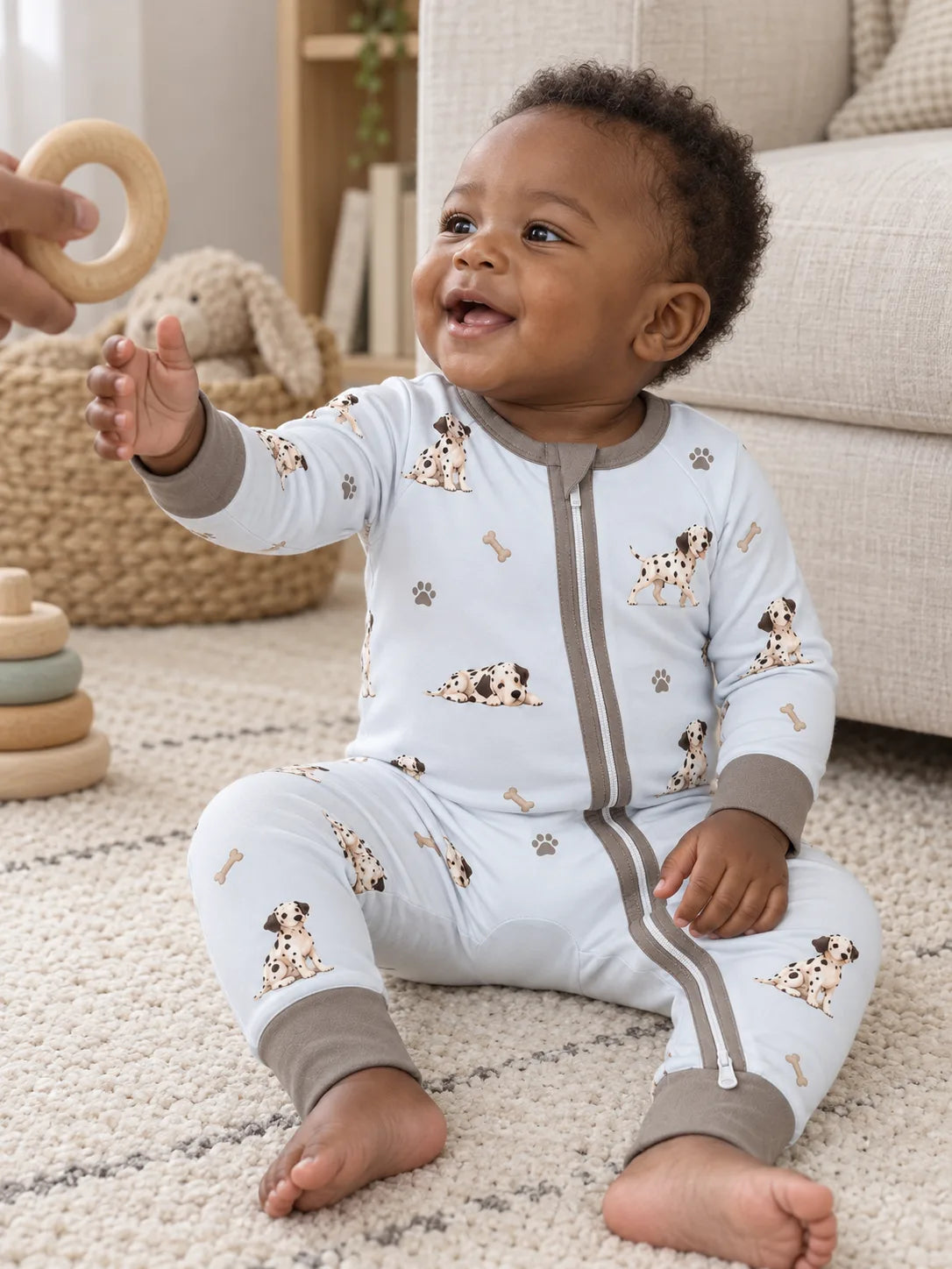 Baby wearing the MossiBaby dalmatian days zipper romper in an indoor lifestyle scene