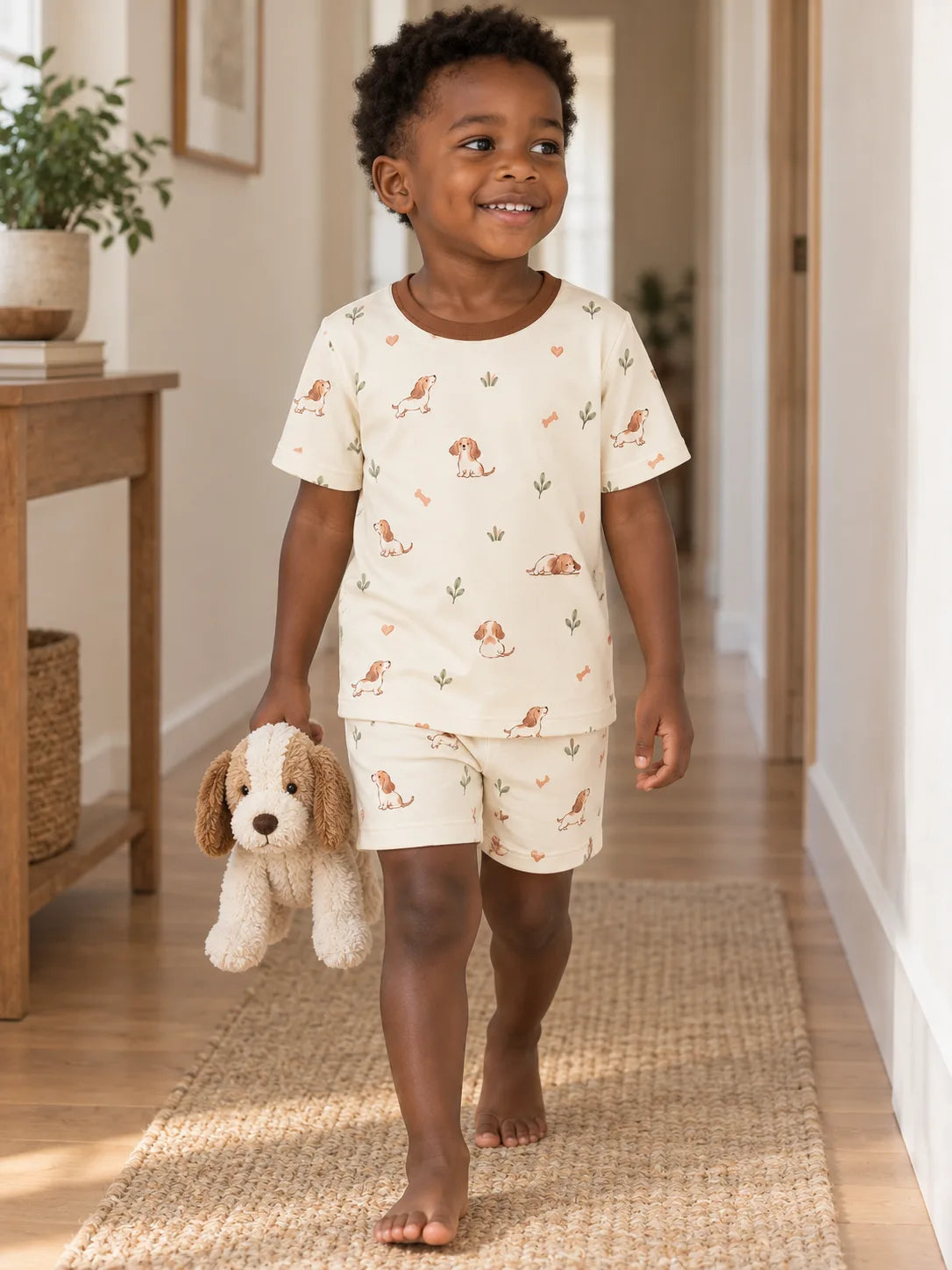 Child wearing the MossiBaby doxie dreams short sleeve pajama set in an indoor lifestyle scene