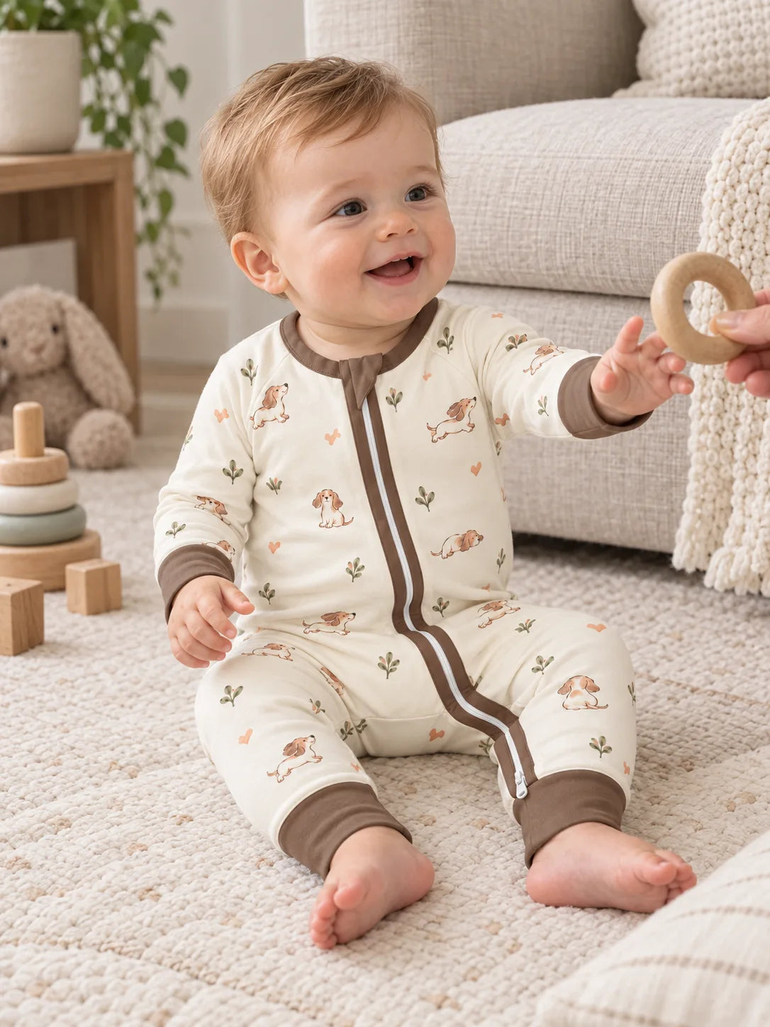 Baby wearing the MossiBaby doxie dreams zipper romper in an indoor lifestyle scene